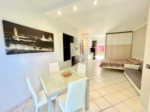 a kitchen and living room with a table and chairs at Premium Apartment Mono C4 in Marina di Bibbona