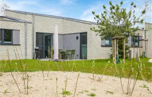 a house on the beach with a tree in the yard at Nice Home In Lembruchdümmer See in Lembruch +45 photos