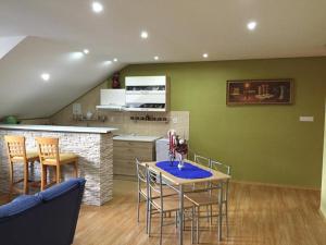a kitchen and dining room with a table and chairs at Apartman u Puškina in Štrba
