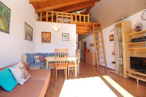 a living room with a couch and a loft bed at Apartment Smokvina P in Baška