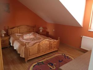 a bedroom with a large wooden bed in a room at Apartman u Puškina in Štrba