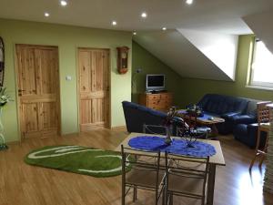 a living room with a couch and a table at Apartman u Puškina in Štrba