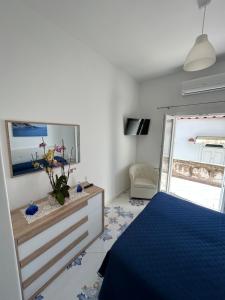 a bedroom with a bed and a dresser and a mirror at Casa Piccina in Praiano