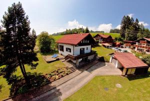 an aerial view of a house with a red roof at Sonnenhäusle Klaus und Sabine Schmid in Immenstadt im Allgäu