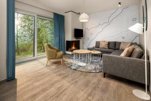 Terhills Resort by Center Parcs في ديلسن - ستوكيم: غرفة معيشة مع أريكة وطاولة