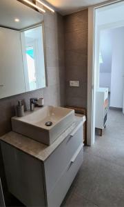 a bathroom with a white sink and a mirror at Atico a dos minutos de la playa in Fuengirola