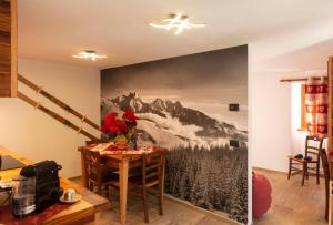 a dining room with a mountain mural on the wall at Bilocale nel cuore del Cervino in Valtournenche