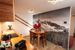 a kitchen with a table with a mountain mural on the wall at Bilocale nel cuore del Cervino in Valtournenche