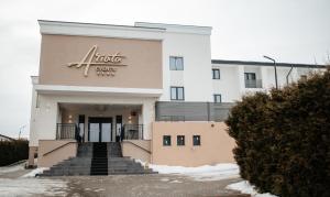 a building with a sign on the front of it at Hotel Ariata in Scheia