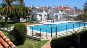 una gran piscina frente a algunas casas en Chalet del Sol en El Faro, en Mijas Costa