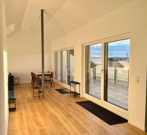 a dining room with sliding glass doors and a table with chairs at Apartment Lili-PS5-Terrace-View-Bright-Kitchen-2xBedroom in Offenbach