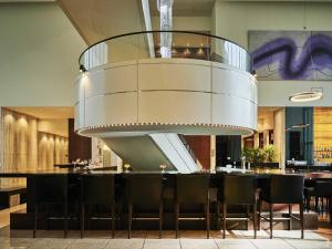 a chandelier in a restaurant with a table and chairs at The Royal Park Hotel Iconic Tokyo Shiodome in Tokyo