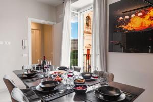 a dining room table with plates and bowls of food at Casa San Lio in Noto