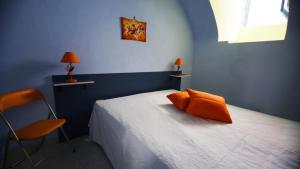 a blue bedroom with a bed and a chair at Appartamento Gallipoli in Gallipoli +106 photos
