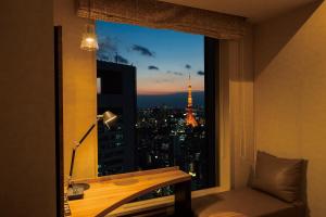 a room with a window with a view of the eiffel tower at The Royal Park Hotel Iconic Tokyo Shiodome in Tokyo
