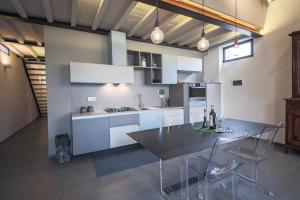 a kitchen and dining room with a table and chairs at Apartments Florence Pepi attic in Florence
