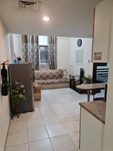 a living room with a couch and a table at Almond Tower, Garden City in Ajman 