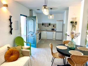 a living room with a couch and a table with chairs at Casa El Barranco By Solymar Holiday in Vélez-Málaga