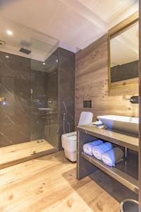 a bathroom with a shower and a sink and a toilet at The Fern Residency Calangute-Baga, Goa in Calangute