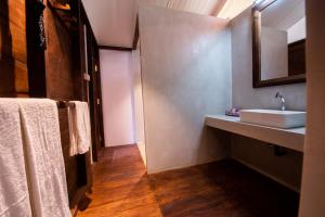 a bathroom with a sink and a mirror and towels at Wild Trails Yala by Suri in Yala