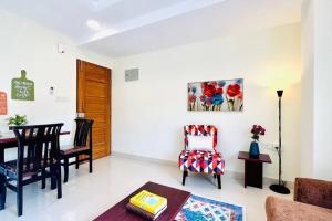 a living room with a table and chairs at BluO 1BHK Suite Gachibowli - Terrace Garden, Lift in Hyderabad