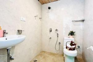 a bathroom with a toilet and a sink at BluO 1BHK Suite Gachibowli - Terrace Garden, Lift in Hyderabad