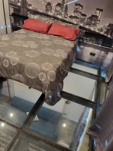 a bed on a glass floor in a room at moraleja suite 3 in Alcobendas