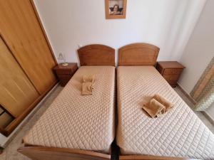 a twin bed with two teddy bears sitting on it at Torre da Aldeia by Umbral in Albufeira