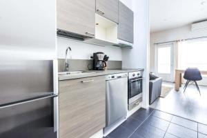 a kitchen with stainless steel appliances and a window at SkyVillas B29 in Kalajoki