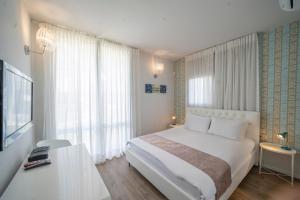 a bedroom with a white bed and a large window at Modern Villa-Ella Sun Eilat in Eilat +79 photos