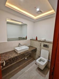 a bathroom with a sink and a toilet at Sun-Rise view Luxury apartment Gold Crest Mall in Lahore