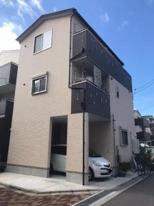 a building with a car parked in front of it at Osaka - House - Vacation STAY 13828 in Osaka