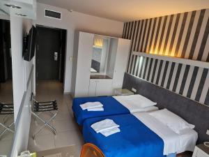 Postel nebo postele na pokoji v ubytování Kyridis Hotel