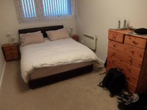 a bedroom with a large bed and a dresser at Near Center of Aberdeen with Parking in Aberdeen