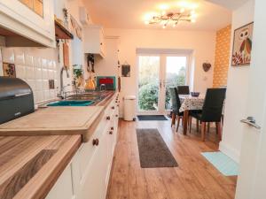 a kitchen with a sink and a table with chairs at Seaside House in Scarborough