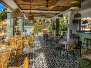a restaurant with tables and chairs on a patio at Cullera Beach Apartment Cap Blanc in Cullera