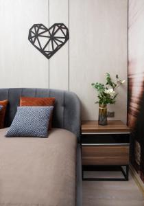 a room with a couch and a heart hanging on the wall at Apartment & Parking "Opera at the corner" in Odesa