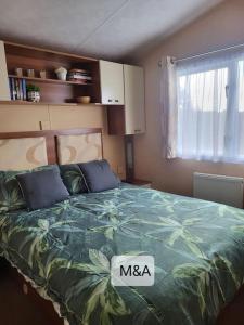 a bedroom with a bed with a msa sign on it at Slatersaunders56 in Meliden