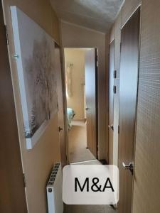 a bathroom with a white sink and a mirror at Slatersaunders56 in Meliden