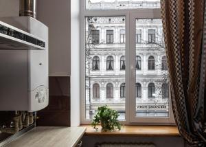 a kitchen with a window view of a building at Apartment & Parking "Opera at the corner" in Odesa