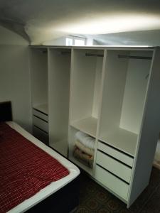 a white closet with a bed in a room at Drachenhöhle in Oldenburg