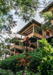 a tree house in the middle of a forest at Wayanad Village Resort in Koroth