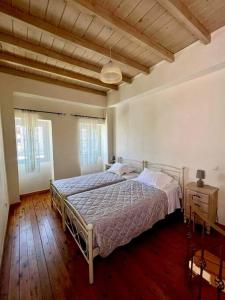 a bedroom with a bed and a wooden floor at Elia Studio in Sokrakion