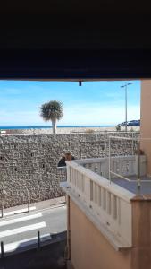 a building with a stone wall and a palm tree at Vieille Ville 2 - La Petite Maison à Safranier, 2 bedrooms, max 4 adults and 2 kids in Antibes