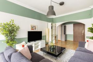 a living room with two couches and a flat screen tv at Superb Flat near Bagdat Street in Kadikoy in Istanbul