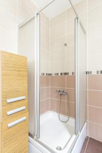 a shower with a glass door in a bathroom at Superb Flat near Bagdat Street in Kadikoy in Istanbul