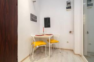 a small table and two chairs in a room at Galaxy studio near Bucharest Old Town in Bucharest +8 photos