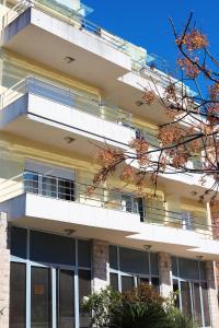 an apartment building with balconies and trees at Lemon Hill in Herceg-Novi