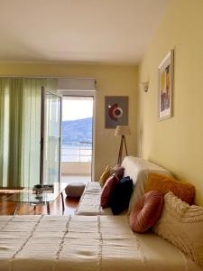 a bedroom with a bed with a view of the ocean at Lemon Hill in Herceg-Novi