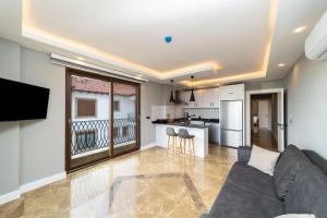 a living room with a couch and a kitchen at Sea View Flat with Hot Tub in Antalya Kas in Kas